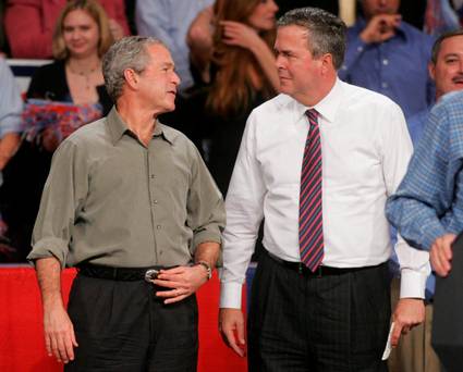 Former President George W. Bush jokes with his brother Florida Governor Jeb Bush in Pensacola Florida